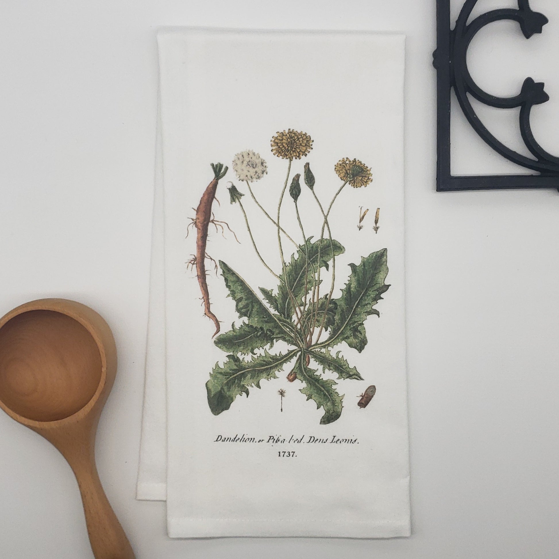 100% cotton kitchen, bar or bathroom tea towel featuring an authentic vintage image of the Dandelion c.1737. Perfect for someone who loves botanicals and dandelions (just not in the grass)! 19"x28" with hanging loop in top corner. Designed, printed, and made in the USA by Heart in Hand Mercantile.